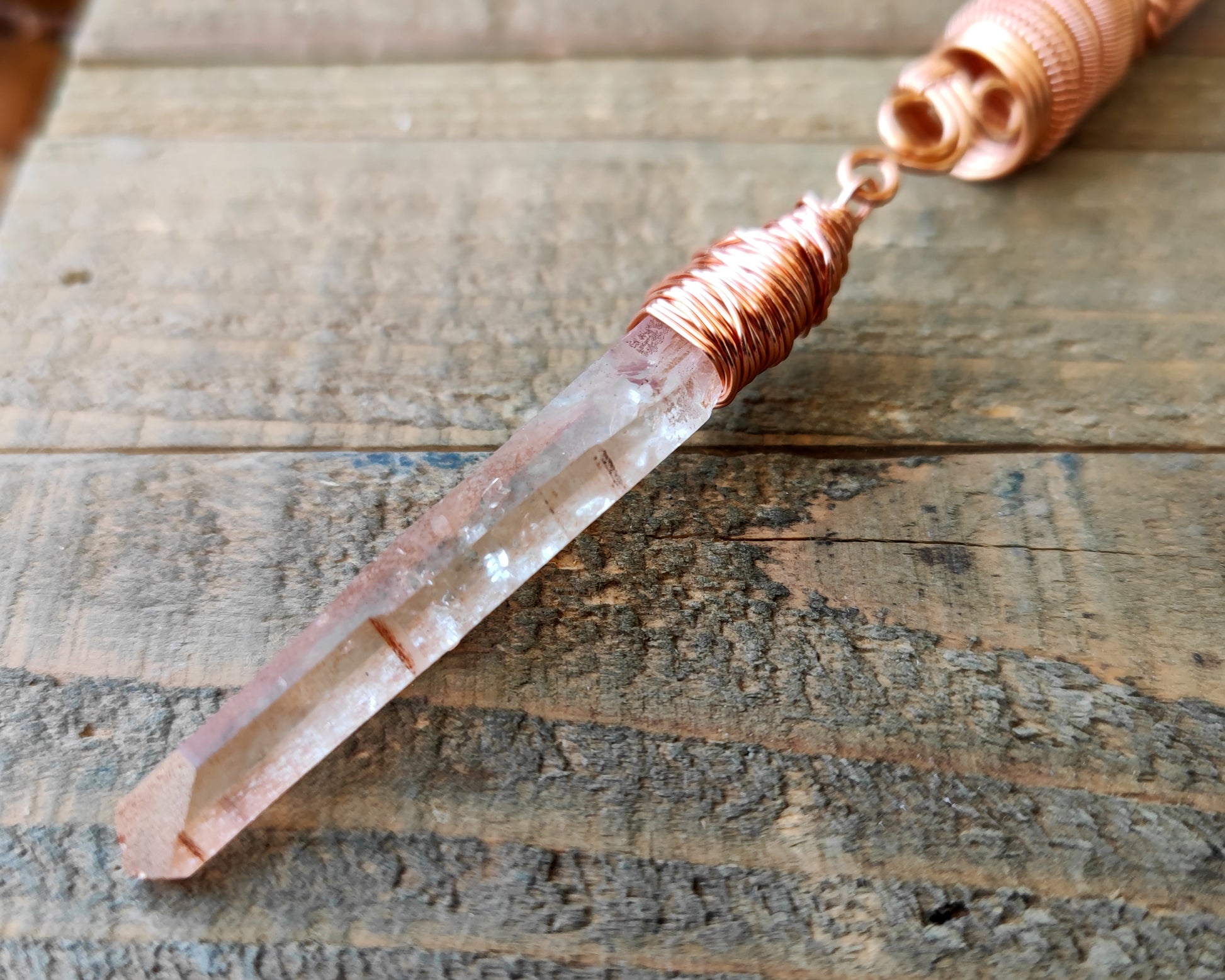 Iron quartz dread bead on wood background.