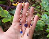 Rose Gold purple Loc Beads, Set of 4 held in hand to show scale.