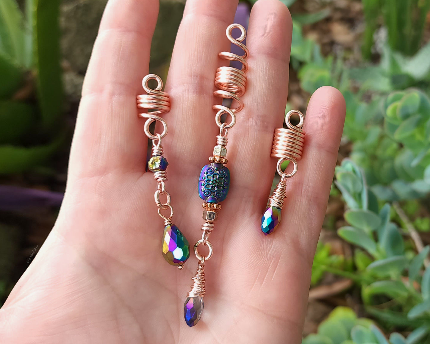 Rose Gold Rainbow Loc Beads Set in hand to show scale.