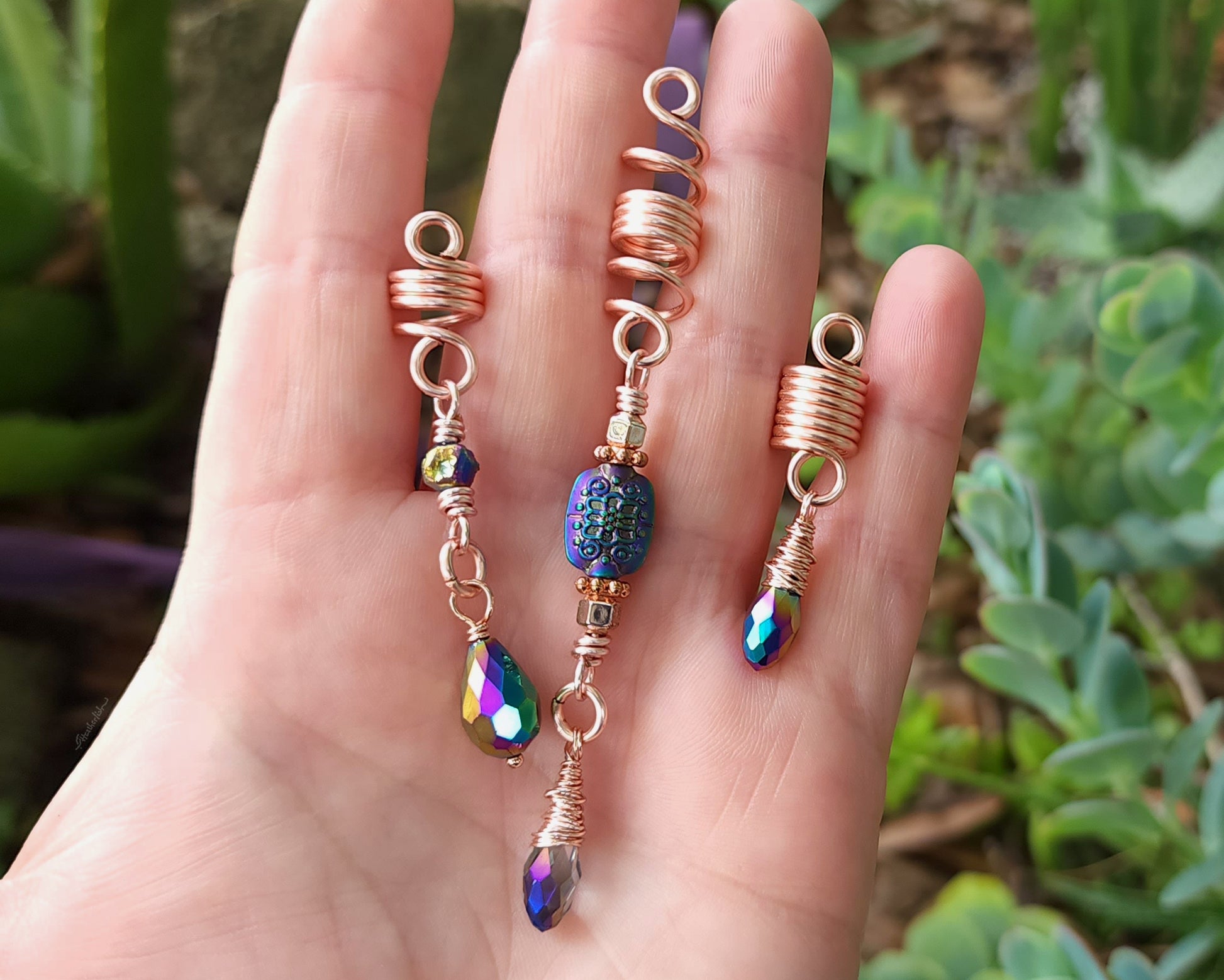 Rose Gold Rainbow Loc Beads Set in hand to show scale.