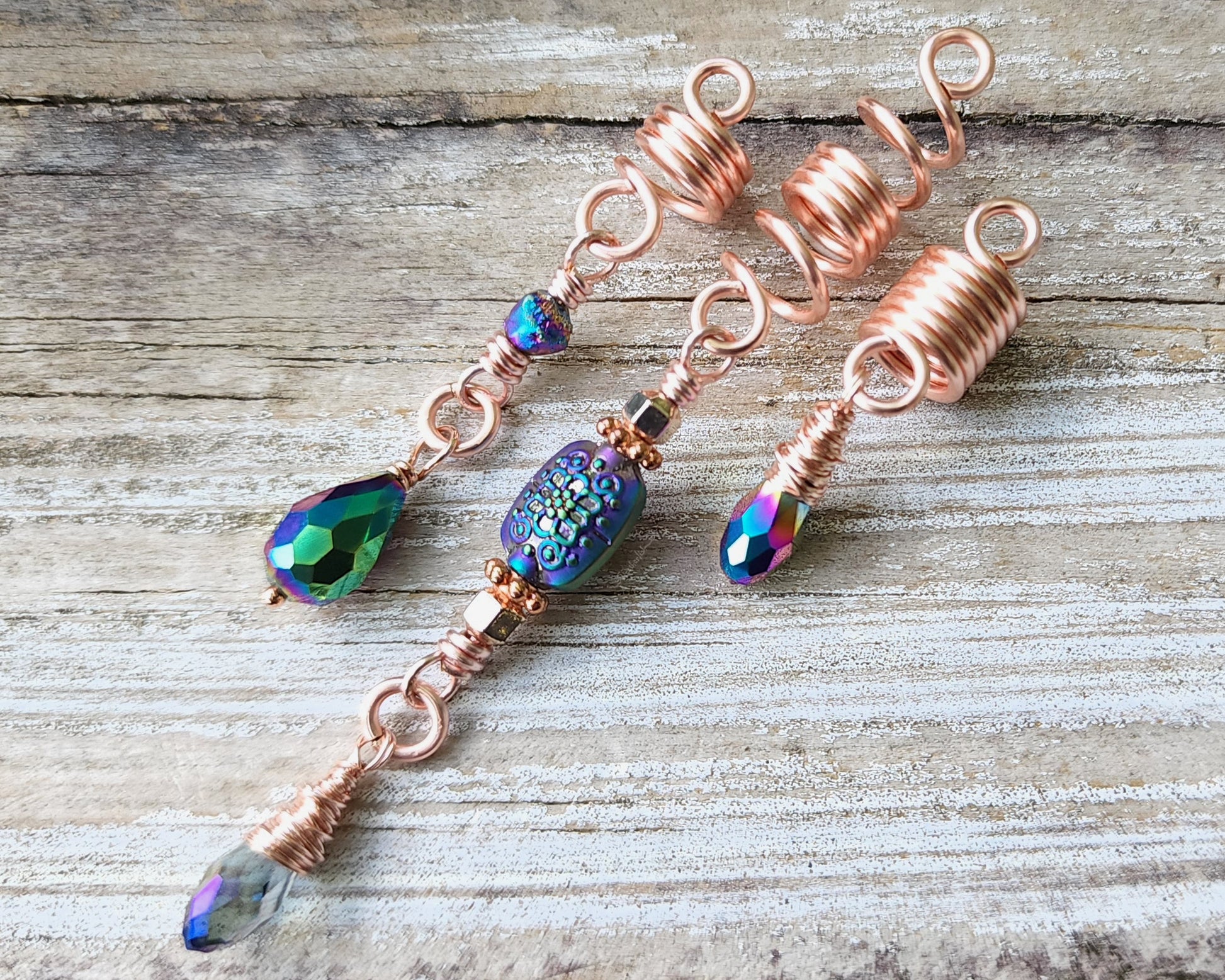 Rose Gold Rainbow Loc Beads Set on a wood background.