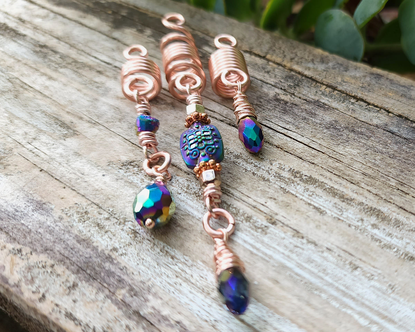 Rose Gold Rainbow Loc Beads Set on a wood background.