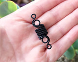Woven Filigree Dread Bead held in hand to show scale.