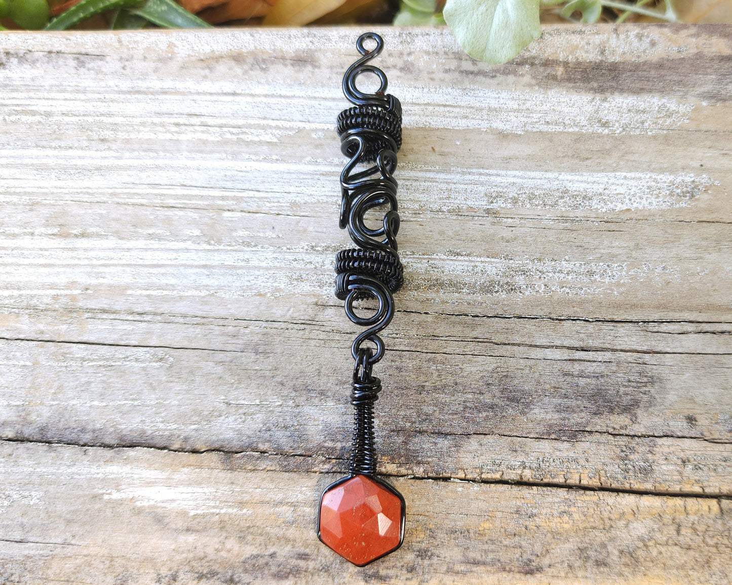 Jasper squiggle loc jewelry on wood background.