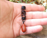 Red Jasper Flat Tear Drop Loc Bead held in a hand to show scale.