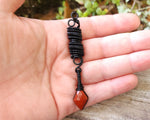 Red Jasper Loc Bead held in hand to show scale.