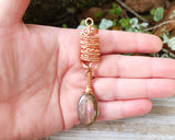 Pink Labradorite Loc Bead held in hand to show scale.