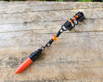 Orange Spike Loc Bead, Black Wire on wood background.