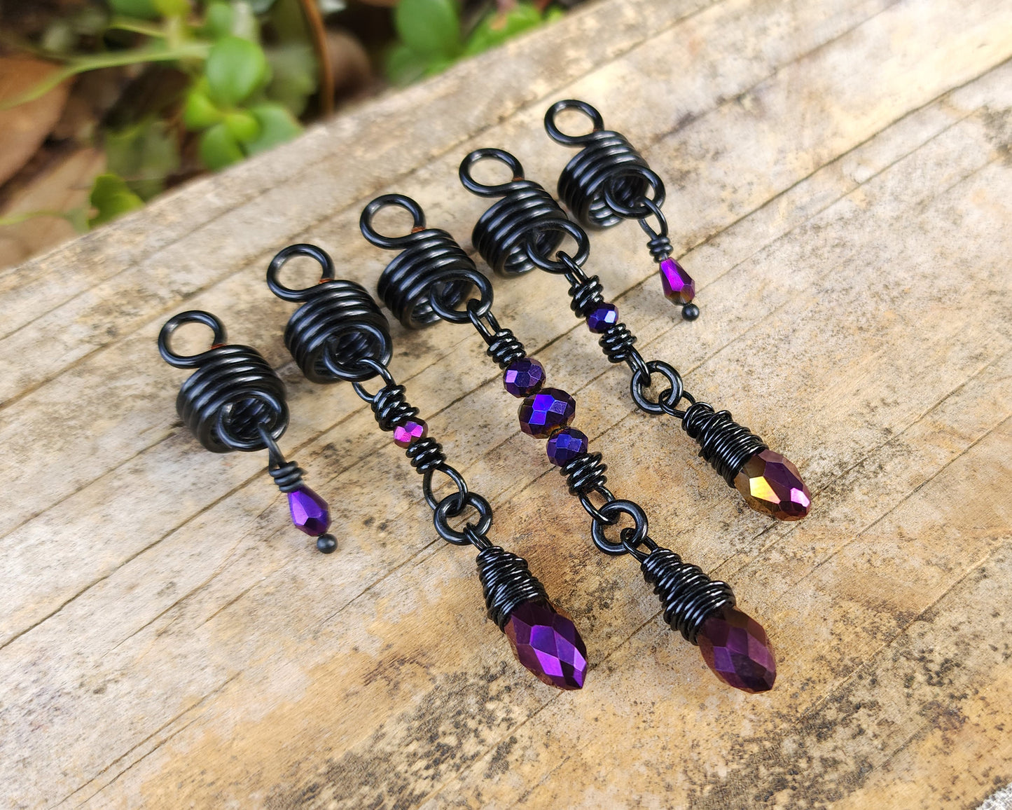 Purple and Black Loc Beads, Set of 5 on a wood background.