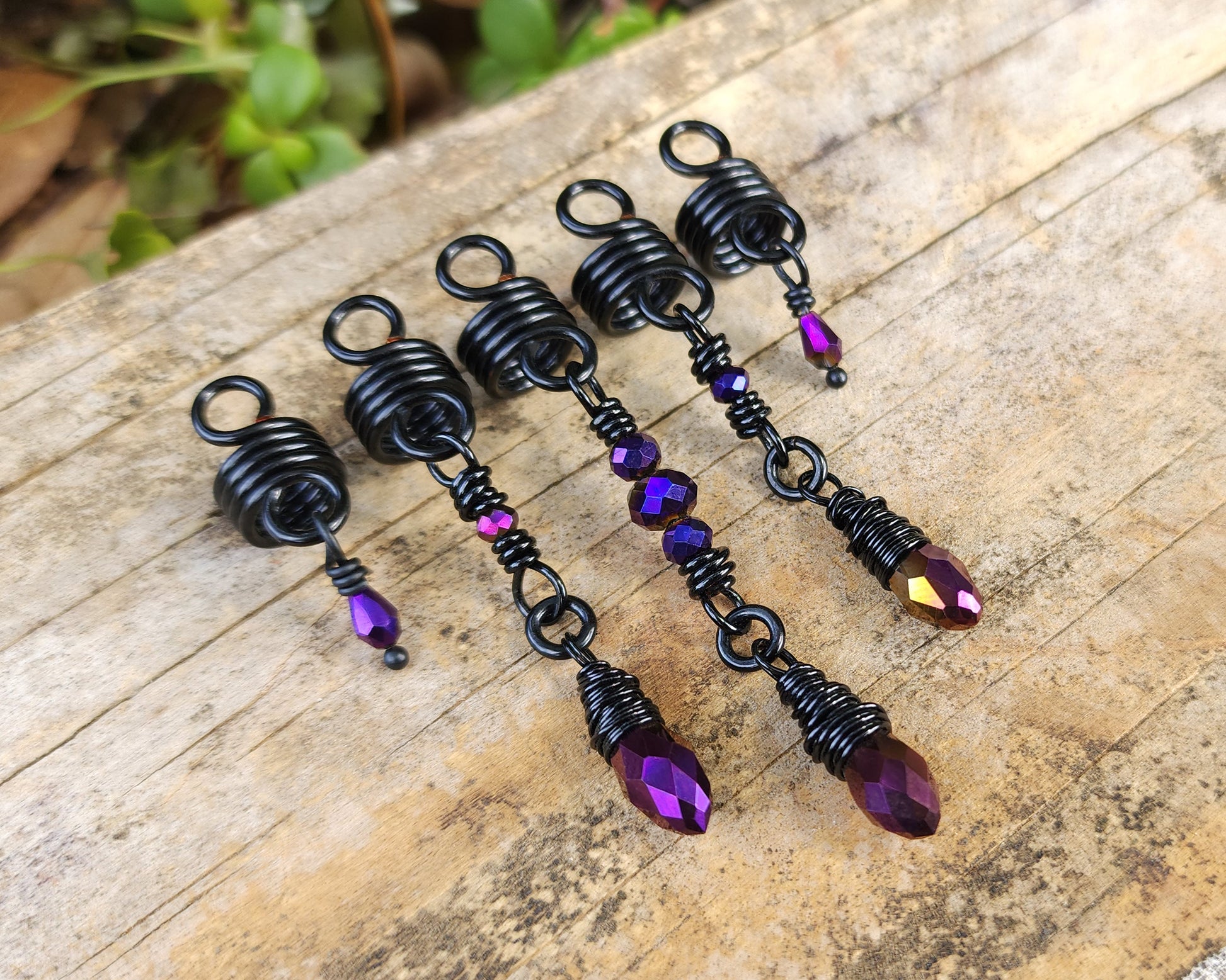 Purple and Black Loc Beads, Set of 5 on a wood background.