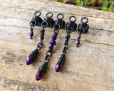 Purple and Black Loc Beads, Set of 5 on a wood background.