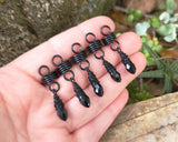 Black Glass Loc Beads, Set of 5 held in hand to show scale.