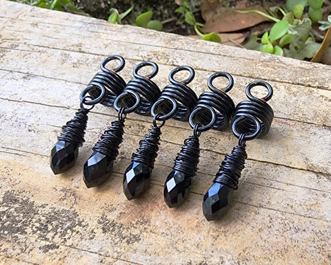 Black Glass Loc Beads, Set of 5 on wood background.