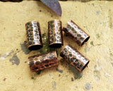 Textured Oxidized Copper Cuffs on a brick background.