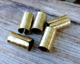 Hammered Brass Hair Cuffs on a wood background.