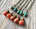 Fire Agate Hubei Turquoise Necklace on wood background.
