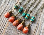 Fire Agate Hubei Turquoise Necklace on wood background.