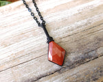 Rose Cut Red Jasper Necklace on a wood background.