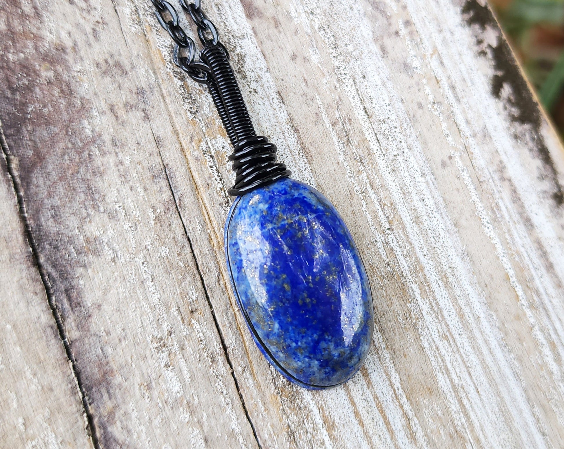 Lapis Lazuli Necklace, Black Chain on wood background.