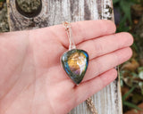 Pear Shape Rainbow Labradorite Pendant held in hand to show scale.