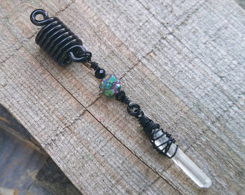 A Black Crystal Loc Bead on a wooden background.
