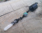 A close up of a Black Crystal Loc Bead.
