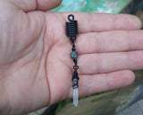 A Black Crystal Loc Bead in hand. 