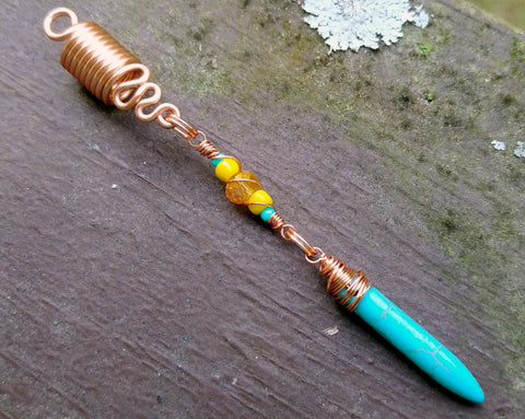A close up view of a Turquoise Spike Dread Bead.