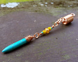A side view of a Turquoise Spike Dread Bead.