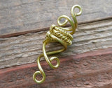 A top view of a Small Woven Brass Dread Bead.