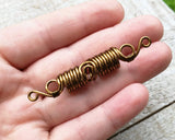 A top view of a Filigree Boho Dread Bead in hand.