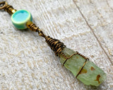 A close up view of a Green Kyanite Squiggle Loc Bead.