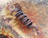 A top view of a Oxidized Copper Loc Bead.