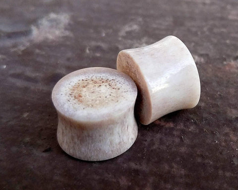 A close up view of Handmade Antler Plugs. 