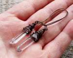 A pair of crystal earrings in hand. 