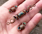 A top view of Copper Turquoise Dread Beads Set of 3 in hand.