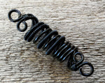 A top view close up of a Black Woven Dread Bead.