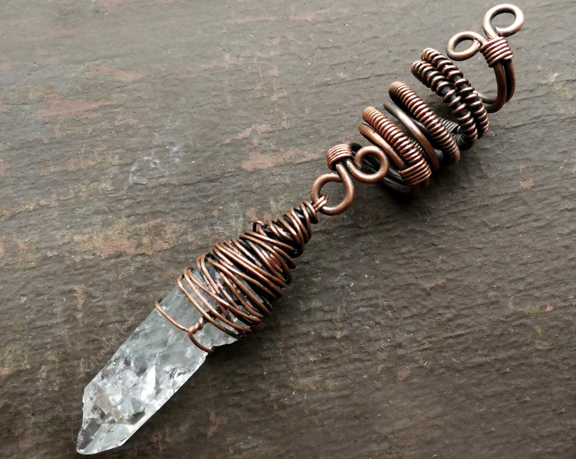 A top view of a Crystal Dread Bead wrapped with Oxidized Copper.