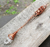 A side view of a Woven Dread Bead with a Arkansas Quartz.