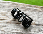A side view of a Hematite Loc Bead.