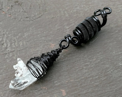 A side view of a Woven Black Crystal Dread Bead.