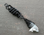 A close up view of a Woven Black Crystal Dread Bead.
