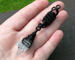 A top view of a Woven Crystal Dread Bead in hand.