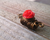 A side view of a Red Rose Dread Bead.