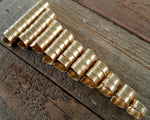 A roll of Varied Length Brass Dread Beads set of 10