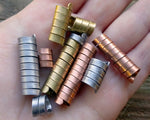 A top view of Mixed Metal Dread Beads Set of 10 in Varied Length in hand.