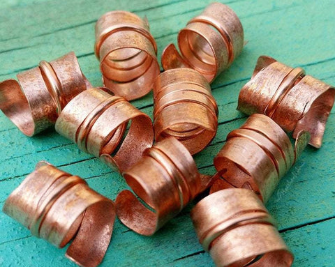 A close up view of Stylized Copper Dread Beads Set of 10.