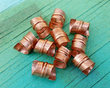 A top view of Stylized Copper Dread Beads Set of 10.