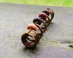A front view of a Earthy Dreadlock Bead.