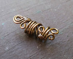 A side view of a Rustic Filigree Dread Bead.
